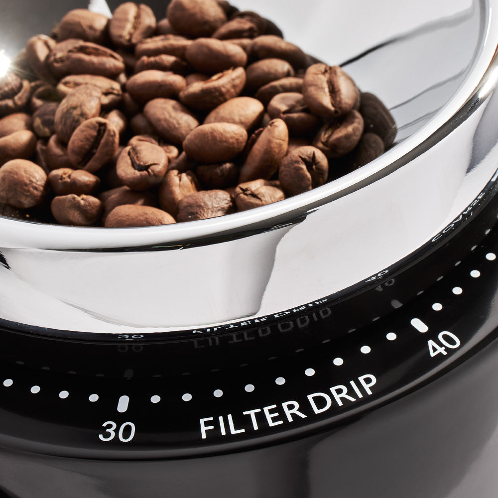 Close up on black Niche Zero with hopper full of beans showing filter drip marking