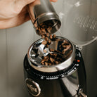 Pouring coffee beans into a Black Niche Zero