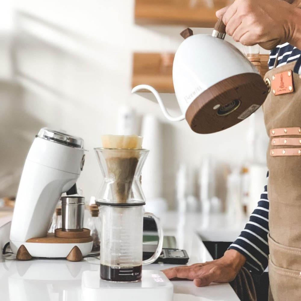 Brewing coffee next to white Niche Zero