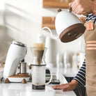 Brewing coffee next to white Niche Zero